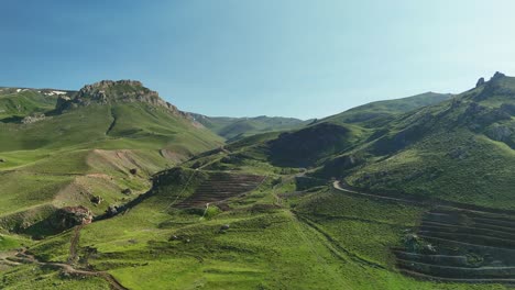 Scenic aerial view of lush green mountains under a clear blue sky