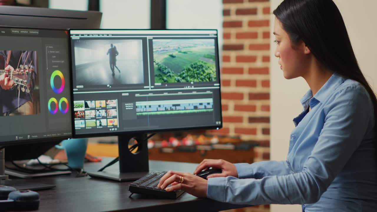 Asian filmmaker editing video and audio footage on multi monitors
