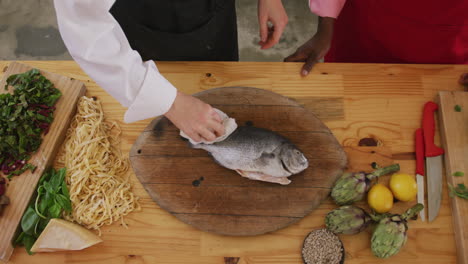 chef cleaning a fish