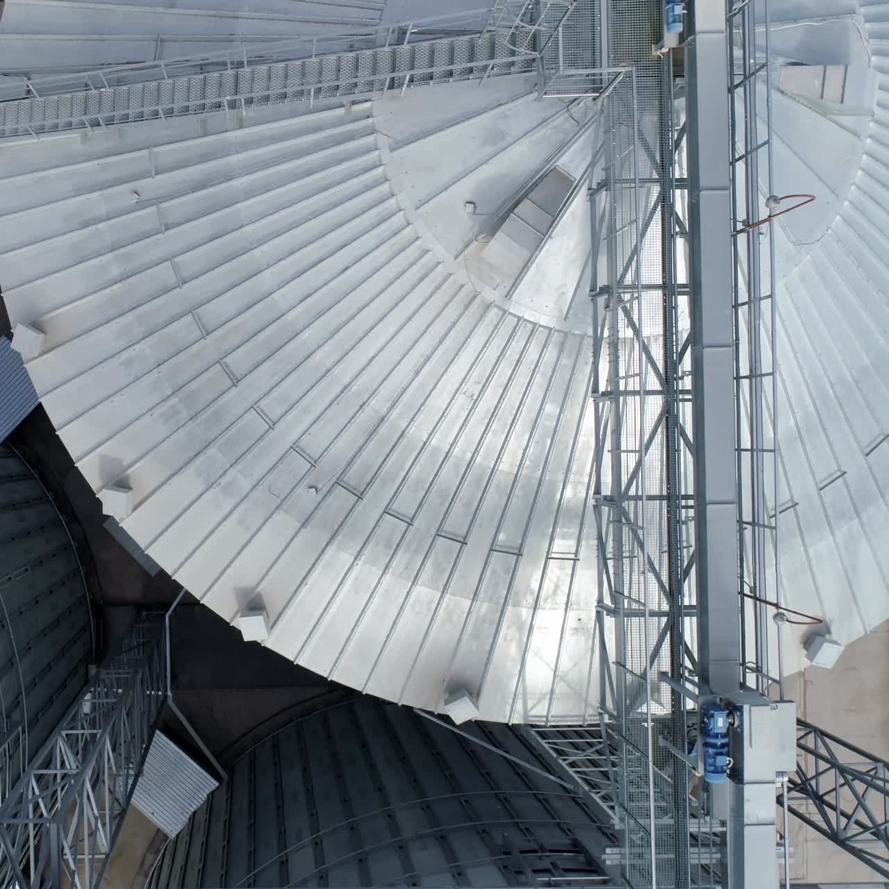 Huge elevator tanks of grain. Metal modern factory tanks. Aerial view