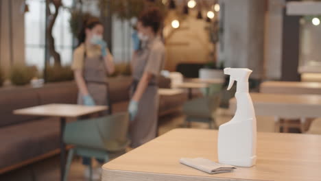 sprayer with disinfectant on cafe table