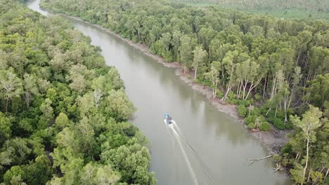 fishing boat at the river of mangrove trees at batu kawan, penang, malaysia.