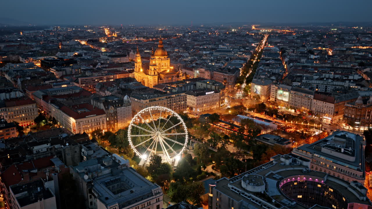 Twilight over Budapest’s heart, where St. Stephen’s Basilica and the glowing Budapest Eye shine amid elegant streets and historic charm
