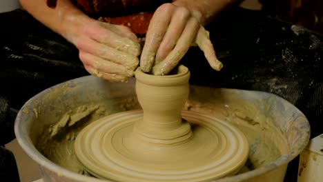 professional male potter making ceramics in workshop