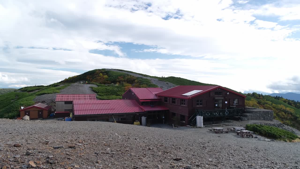 Wide shot of Chogatake Hut on a rocky slope along the Panorama Ginza trail in the Northern Japanese Alps