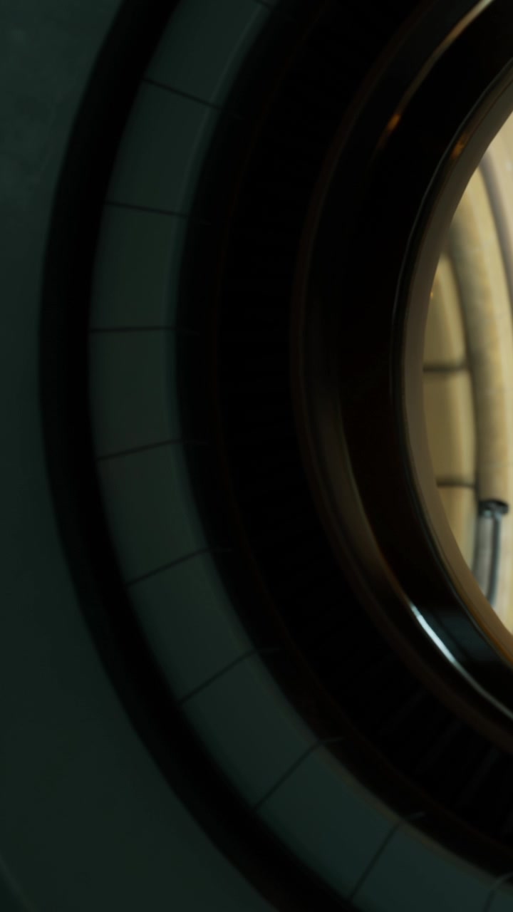 A circular window offers a close view of the surrounding structure