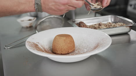 Caucasian-male-chef-decorating-dessert-in-kitchen,-slow-motion