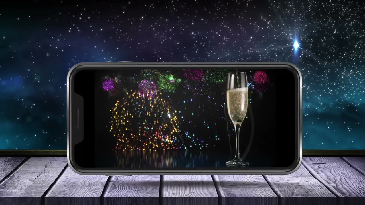 스마트폰 화면에 폭발하는 불꽃놀이와  ⁇ 페인 한 잔의 애니메이션이 표시됩니다.