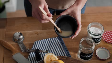 Top-view-of-unrecognizable-person-mixing-DIY-cleaning-product.