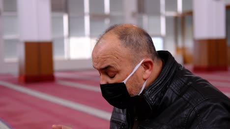 Old-Man-Masked-Raising-His-Hands-And-Praying-In-Mosque-1