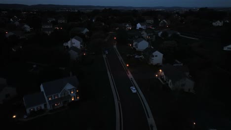lighting housing area in city with parking cars on usa at midnight. lantern and houses in suburb. housing area with community in ohio, united states. slow drone flyover.