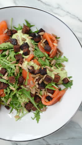 vertical footage fresh ingredients for creating gourmet salads arranged in white ceramic bowls on sleek marble surface, showcasing culinary craftsmanship with greek and salmon salad compositions