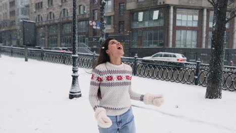 woman enjoying a snowy day in the city