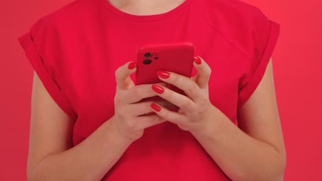 woman holding red phone in red shirt