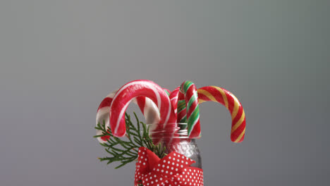 candy canes arranged in a jar 4k