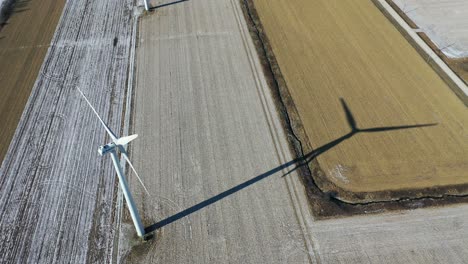 wind turbine on a large field in the cold countryside - ariel video