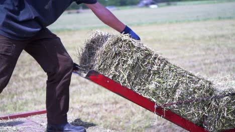 Aerial-Drone-Shot-Flying-Over-Tractors-Harvesting-in-Hay-Field