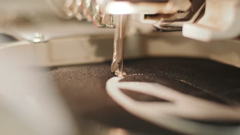 the automatic embroidery machine is working at high speed. close-up