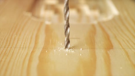 una toma macro en cámara lenta de un carpintero perforando un trozo de madera