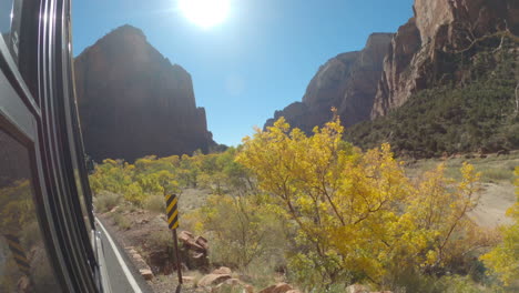 shot of the size of a bus driving through zion national park