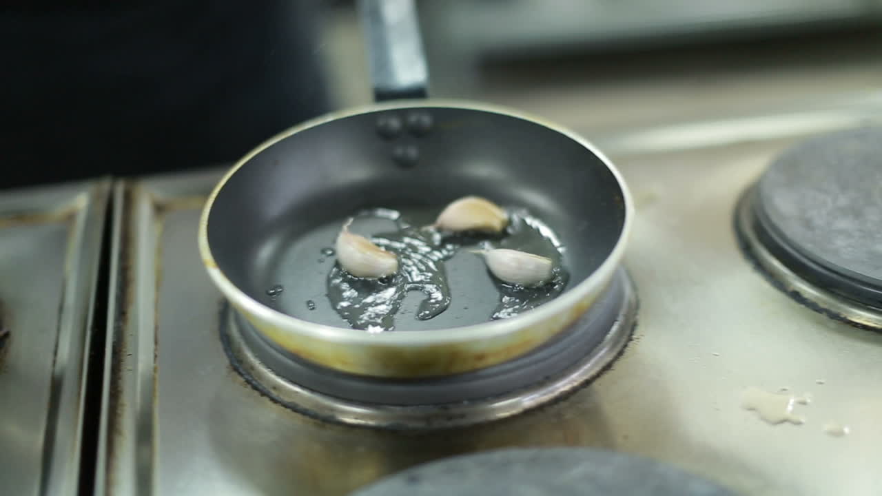 Onion Frying In A Pan. Fried onions in a frying pan in oil, for cooking