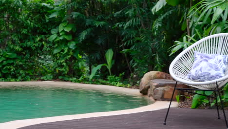 pan across tropical pool area with personal waterfall to outdoor seating area