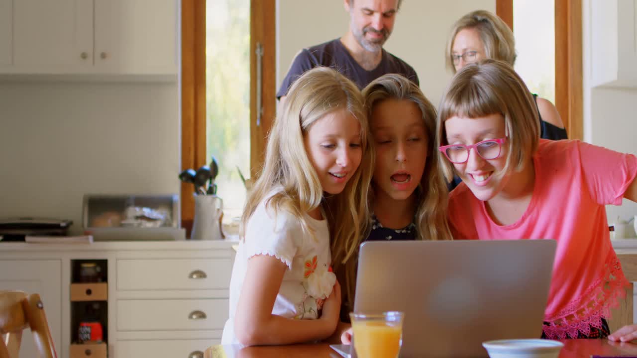 Kids using laptop in kitchen 4k