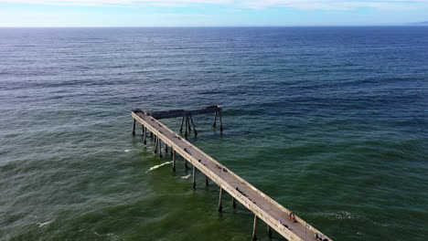 drone shot over the pacifica municipal pier in sunny san francisco bay, usa