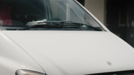 Postman-Delivers-Parcel-To-Recipient-Amid-White-Van