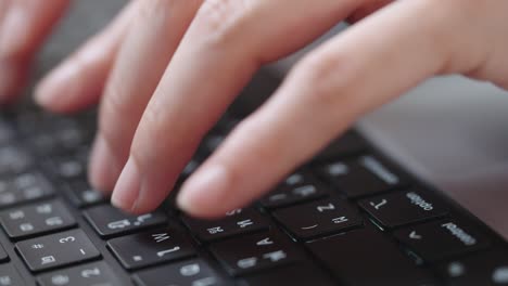 close up shot of businesswoman hands typing on laptop computer keyboard for searching information,online communication support,marketing research,business report in the office desk at night.