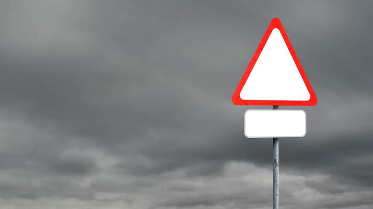 Blank signboard post with copy space against dark clouds in the sky