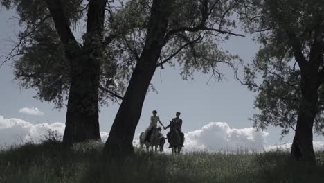 couple on horses in a forest