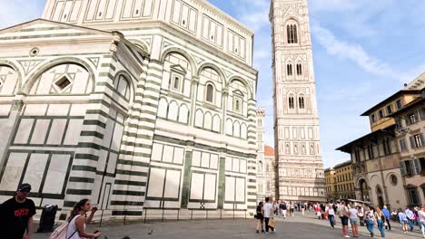 people exploring florence's historic cathedral and square