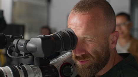 Female-Film-Director-Talking-With-Male-Camera-Operator-Shooting-Movie-Or-Video-In-Studio-3