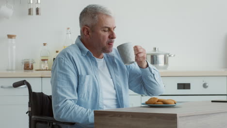 elderly man in wheelchair eating cookies