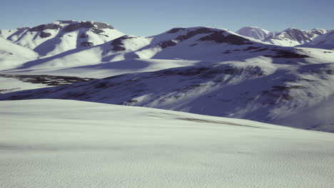 snowy mountain landscape with clear blue sky during daytime in winter