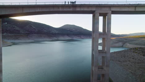 Aerial flying under the suspension bridge on the reservoir of Iznájar, Córdoba, Spain