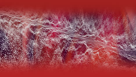 ondas de partículas blancas que se mueven sobre un resplandor rojo en un fondo oscuro