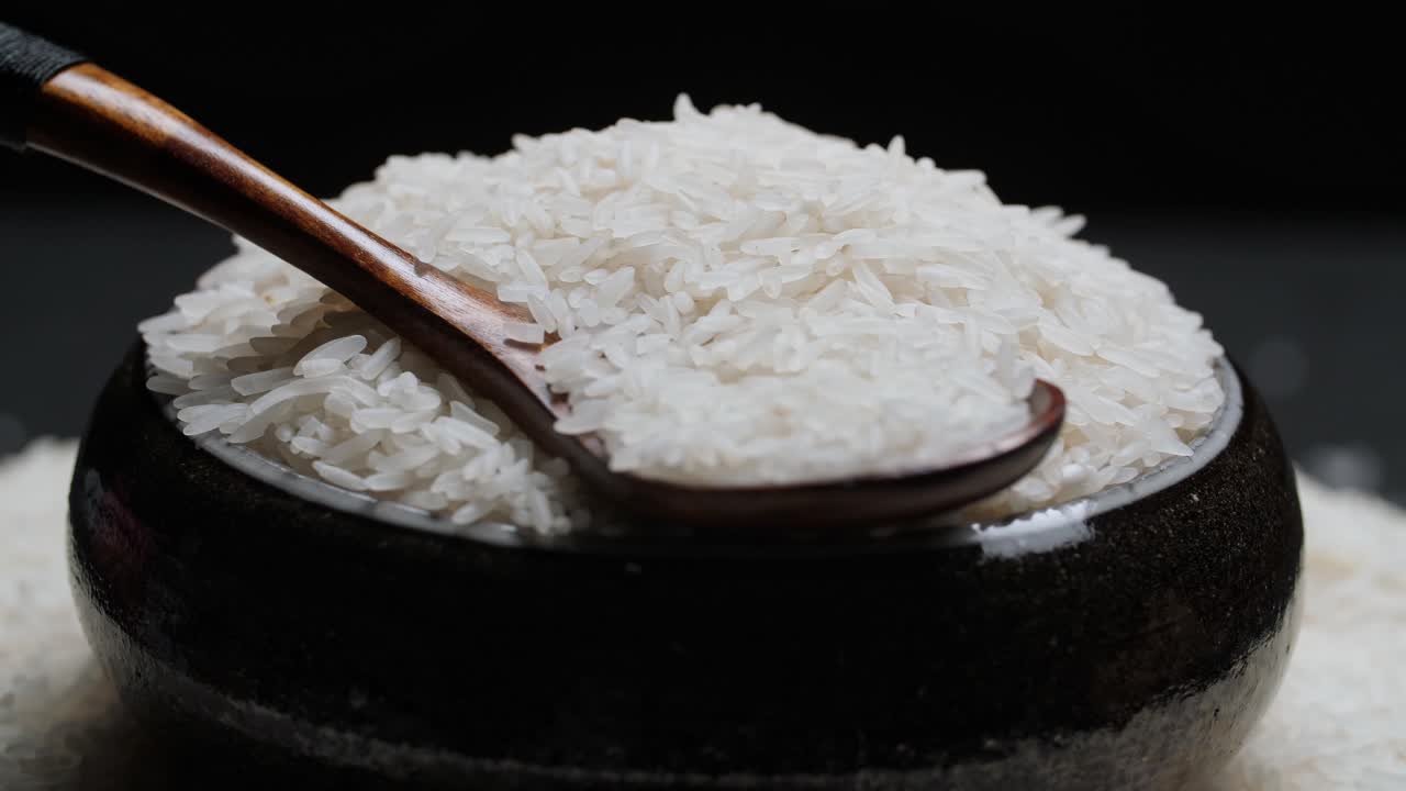Rice Grain In Bowl And Spoon Rotate In Slow Motion