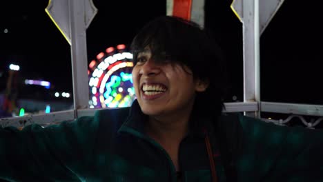 Girl-enjoying-a-Giant-wheel-ride-in-an-indian-fair-at-Pushkar-,-India