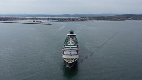 cruise ship aerial drone shot with sete city in background mediterranean sea