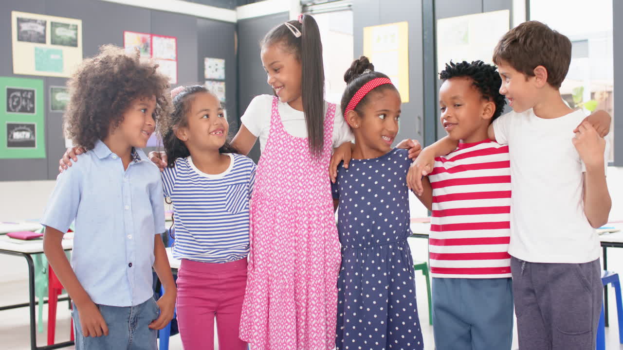 In school, group of children standing together and smiling in classroom
