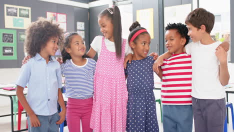in school, group of children standing together and smiling in classroom