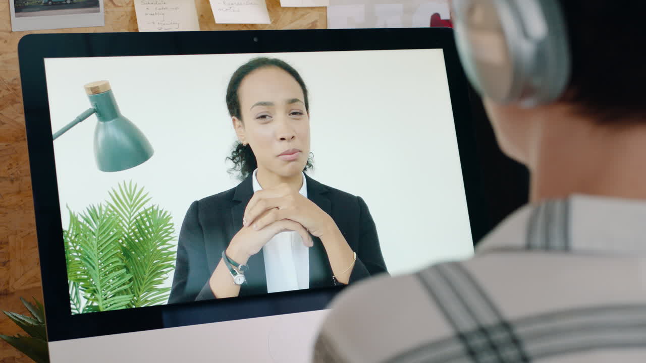 Woman on Video Call with Colleague Wearing Headphones