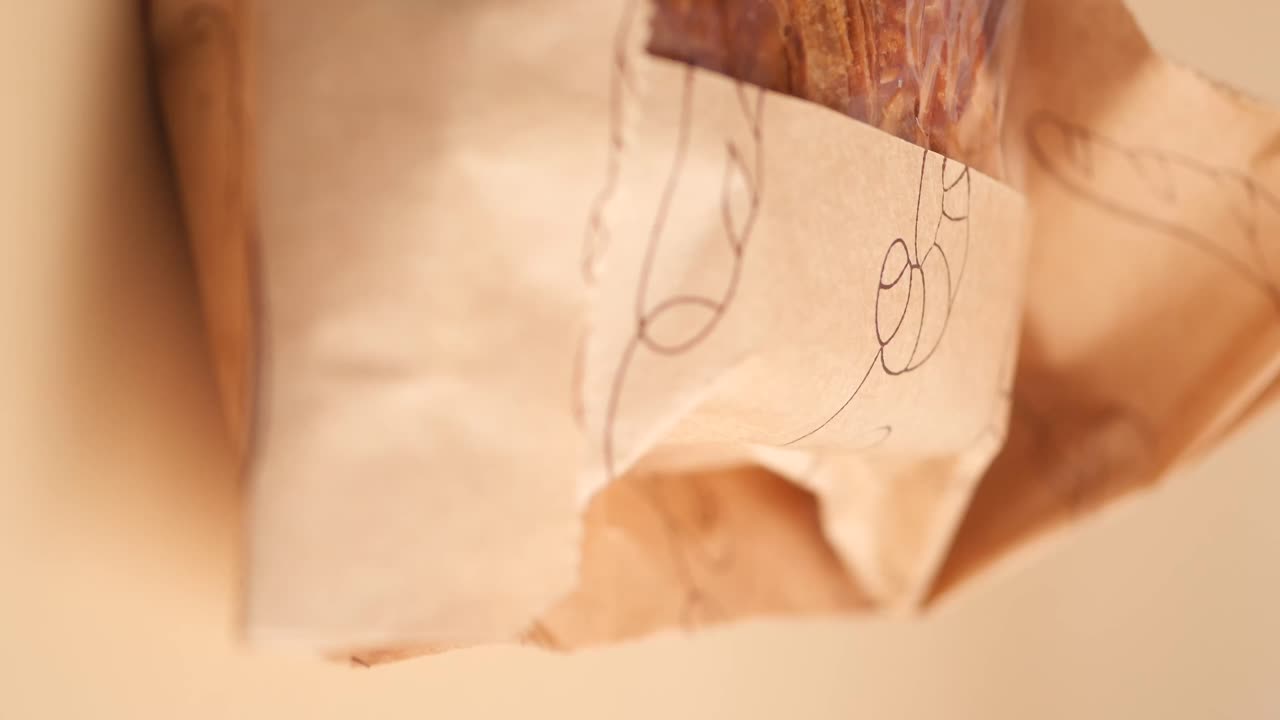 Chocolate croissant in a paper bag