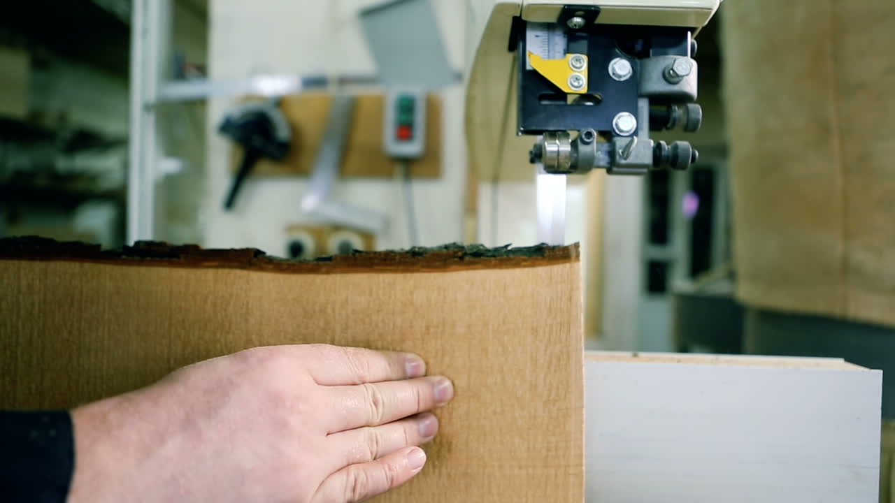 Sawing A Wooden Plank With Jig Saw. Man uses an electric saw to cut wooden planks