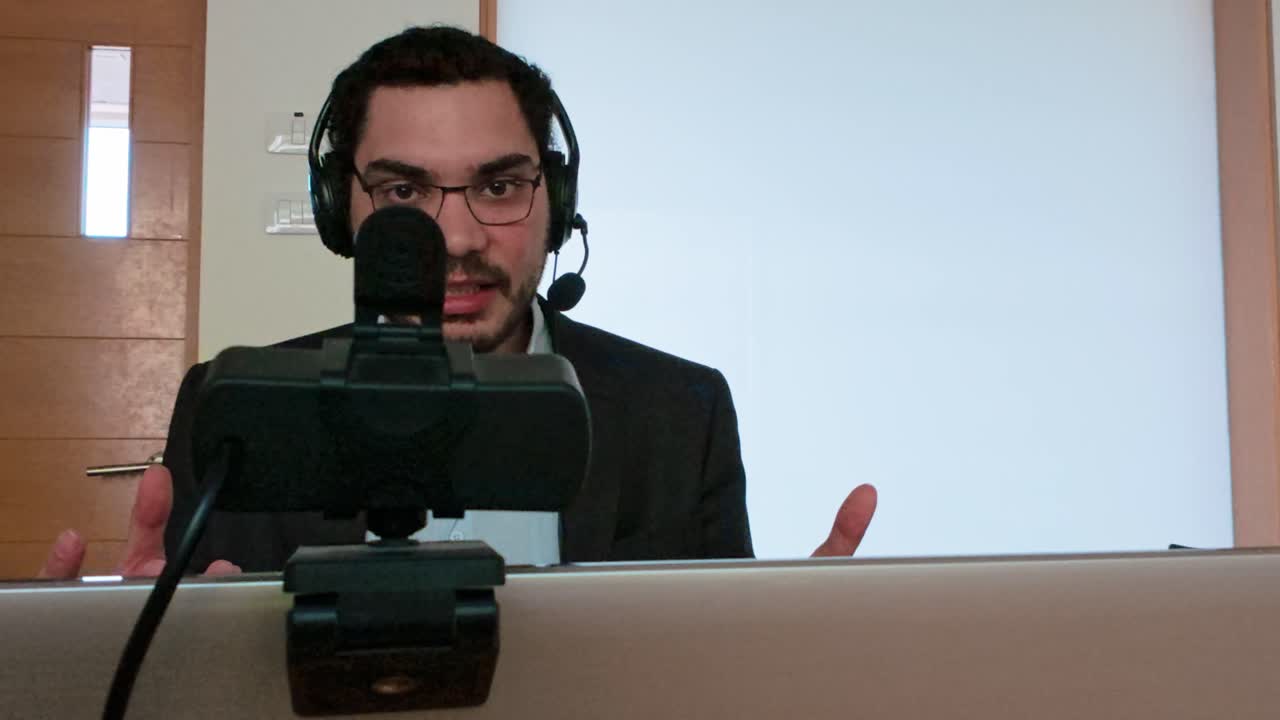 University Student Attending an Online Lecture