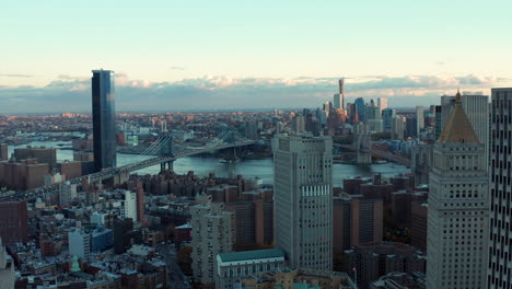 Aerial-footage-of-large-city-and-long-cable-stayed-bridges-across-river.-Morning-shot-in-sunrise-time.-Manhattan,-New-York-City,-USA