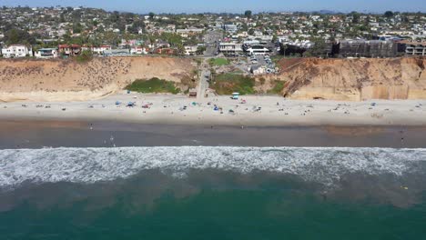 drone shot flying towards solana beach and coastal city in san diego, america