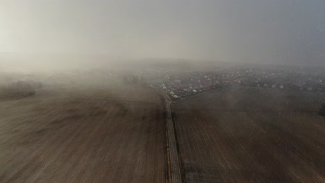 aerial road between brown ground field during blizzard 4k